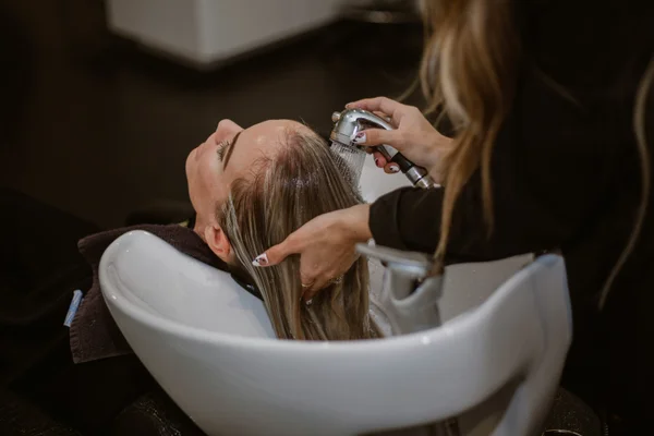 Professional hair styling session with precision cutting techniques